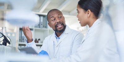 Shot of two scientists having a discussion in a lab