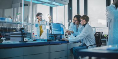 Diverse Team of Multi-Ethnic Young Scientists Analysing Test Samples