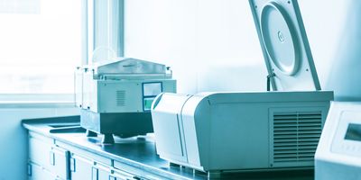 Image of a centrifuge sitting on a lab bench
