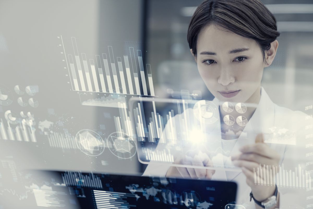 Young female scientist analyzes data on a holographic display Young female scientist analyzes data on a holographic display