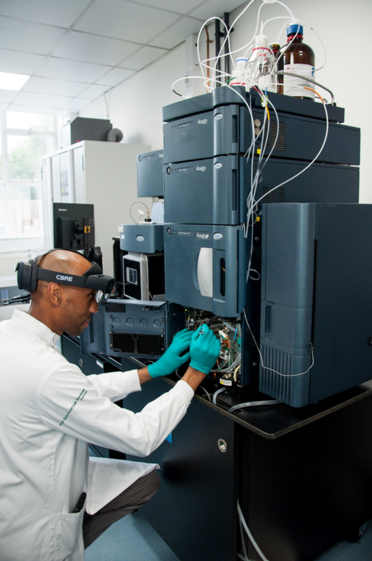 Lab technician services a chromatography system with an XR headset Lab technician services a chromatography system with an XR headset